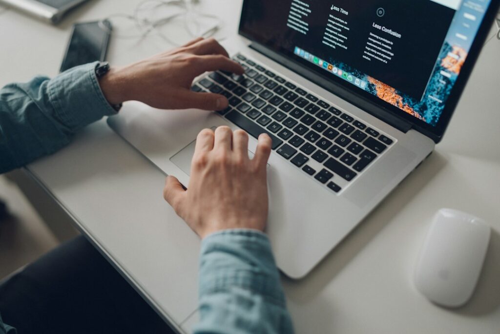 Person researching websites and AI tool directories on a laptop